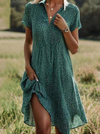 Midi shirt dress featuring short sleeves and a fluid silhouette, perfect for casual or semi-formal occasions. 0