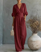 V-Neck jumpsuit for women featuring a tailored fit and luxurious silk-touch fabric, perfect for elegant occasions and stylish outings. 1