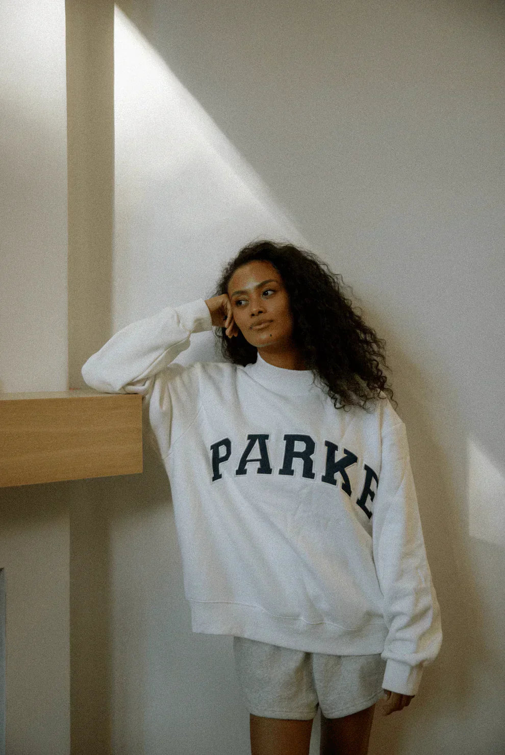 Women's oversized sweatshirt featuring soft chenille lettering, perfect for casual everyday wear and stylish comfort. 8