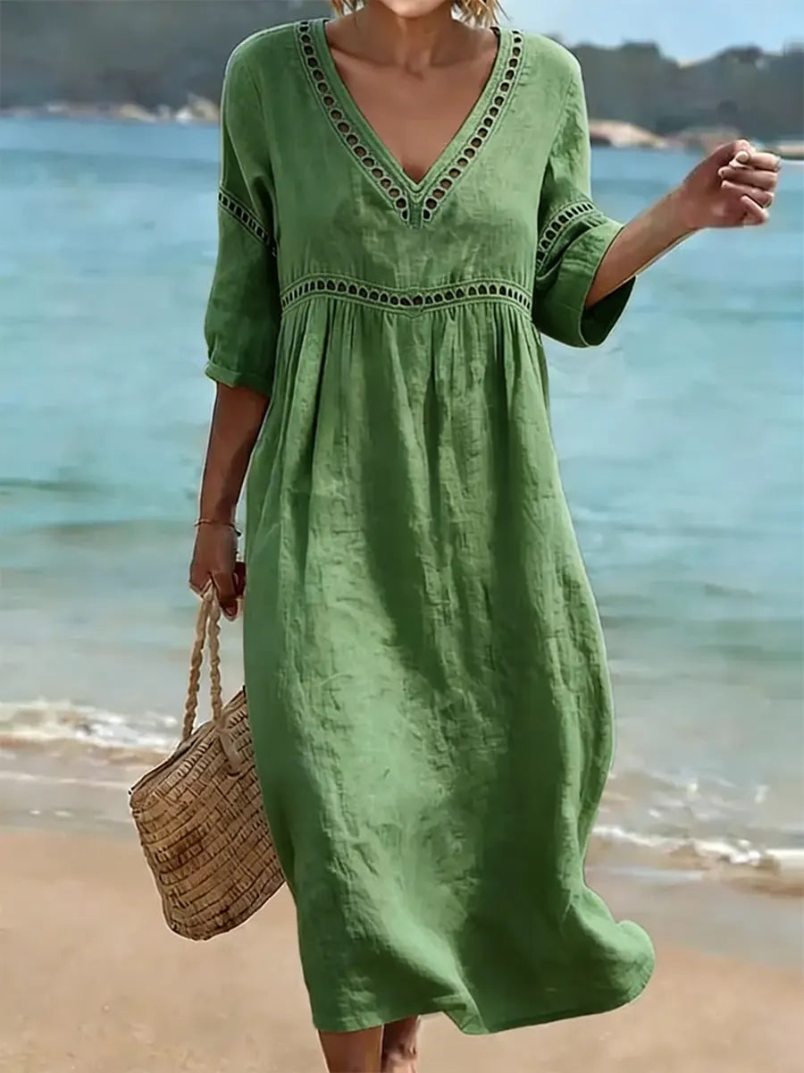 Women's summer V-neck cotton dress featuring a flowy casual style and convenient side pockets, perfect for warm weather outings. 0