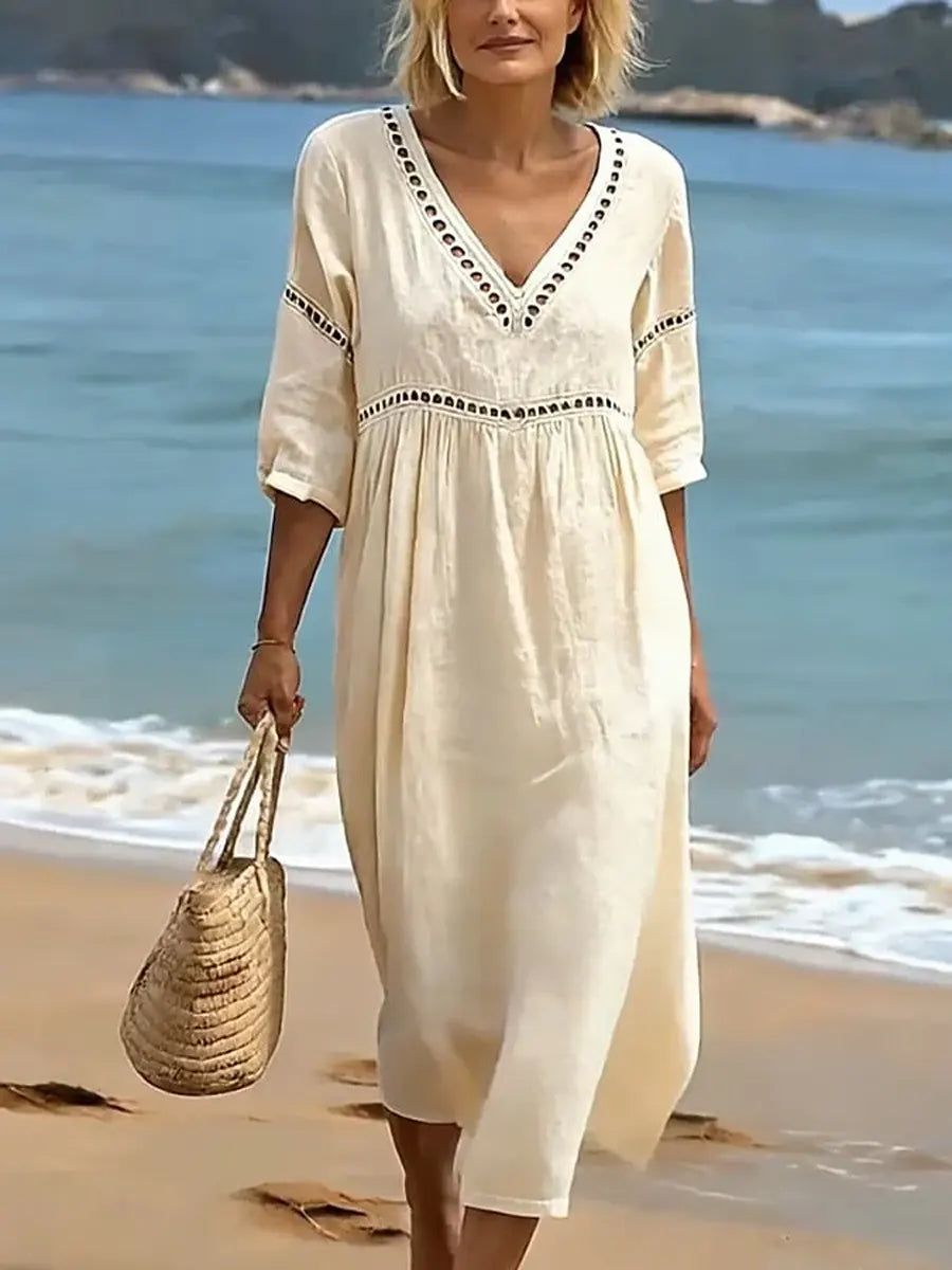 Women's summer V-neck cotton dress featuring a flowy casual style and convenient side pockets, perfect for warm weather outings. 2