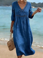 Women's summer V-neck cotton dress featuring a flowy casual style and convenient side pockets, perfect for warm weather outings. 4